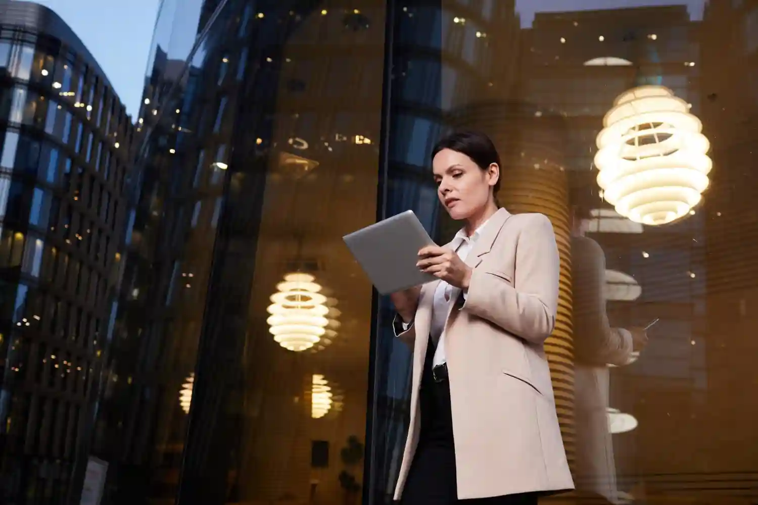 A technology leader reviewing notes outside an evening office